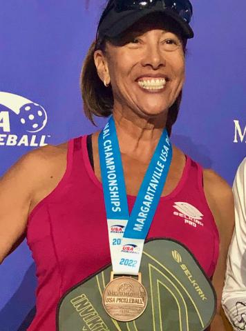 Jeaney smiling with her bronze at Nationals 2022